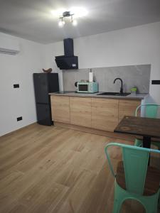 a kitchen with a refrigerator and a table and a microwave at Amonite in Alcalá del Júcar