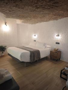 a bedroom with a large bed in a room at Amonite in Alcalá del Júcar