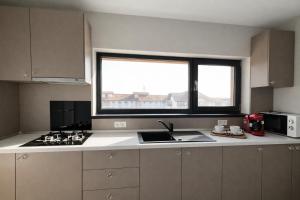 a kitchen with a sink and a window in it at Seranova Aparthotel 10 SELF CHECK-IN #Otopeni #Airport #Therme #Bucharest in Otopeni