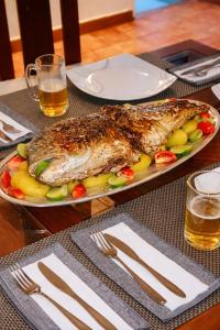 a large fish on a plate on a table at Bluewind Hotel in Tangalle