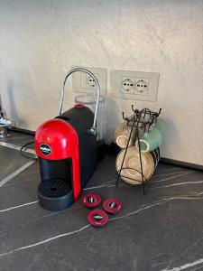 a red sewing machine sitting next to a wall at La Piazzetta in Sondrio