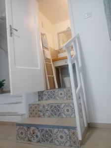 a staircase in a house with tiles on the stairs at CASA COTA in Mattinata