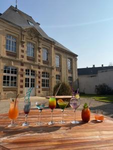 a row of wine glasses sitting on a wooden table at Belle Normandy in Bayeux