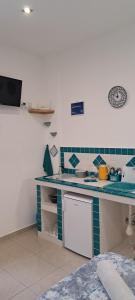 a kitchen with a blue and white counter top at ortigia adriana suite in Syracuse