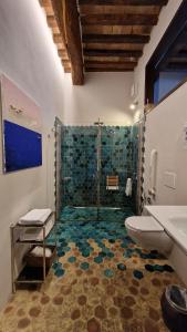 a bathroom with a shower with a toilet and a sink at Domus Calzolari in Gubbio +36 photos