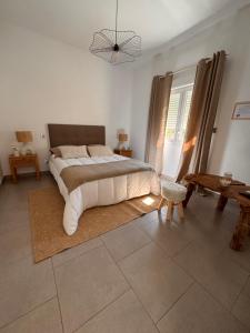 a bedroom with a large bed and a large window at les chambres d'hotes du chalet in Venaco