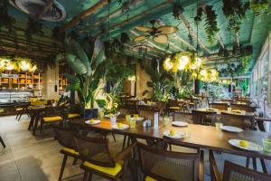 a restaurant with tables and chairs and plants on the ceilings at Anjeliq Downtown Boutique Hotel in Alanya +78 photos