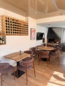 a tasting room with tables and chairs and a fireplace at les chambres d'hotes du chalet in Venaco