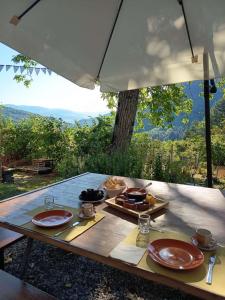 a table with plates of food on top of it at Agricampeggio Boschetto Gioioso in Barbiano