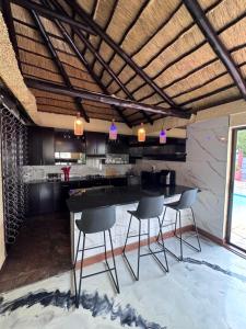 a kitchen with a table and chairs in a room at Countryview Chalet in Benoni