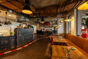a restaurant with wooden tables and a bar at Motorworld Inn Hotel Böblingen in Böblingen +14 photos