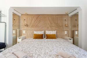 a bedroom with a large bed with two pillows at Rossio individual Suites Lisbon in Lisbon