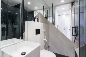 a white bathroom with a sink and a shower at Rossio individual Suites Lisbon in Lisbon +33 photos