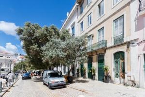a van parked on a street next to a building at Rossio individual Suites Lisbon in Lisbon