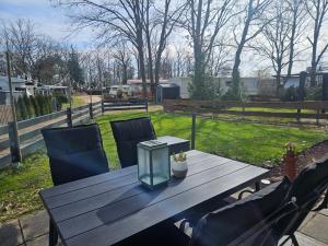 a wooden table with two chairs and a box on it at Finnhaus 1 Strandbad Adria in Kleutsch