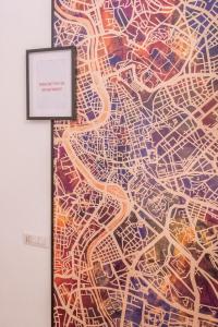 a painting of a city on a wall at Boschetto 58 in Rome
