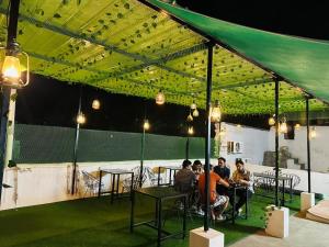 a group of people sitting at tables under a tent at Hotel Panna Haveli in Jaipur