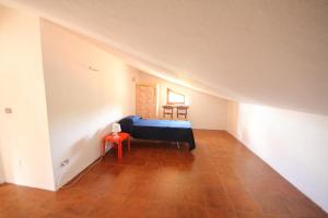 a bedroom with a bed and two chairs in a attic at Villa Pentalocale cod 168- Taunus Vacanze in Numana
