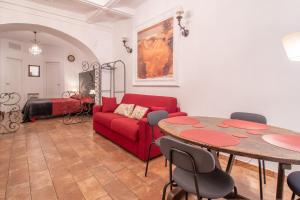 a living room with a red couch and a table at Boschetto 58 in Rome