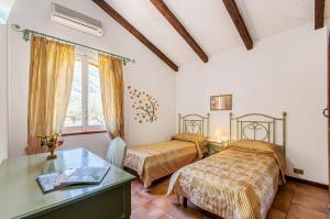 a hotel room with two beds and a desk at Villa Le Sterlizie in Castellammare del Golfo +28 photos