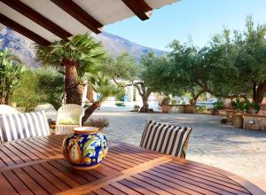 a vase sitting on a wooden table on a patio at Villa Le Sterlizie in Castellammare del Golfo