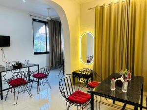a dining room with black tables and red chairs at Hotel Panna Haveli in Jaipur