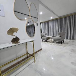 a room with a mirror and a table and chairs at Nandoni Waterfront Resort in Thohoyandou +290 photos