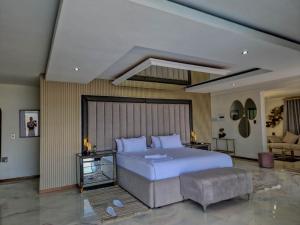 a bedroom with a large bed and a couch at Nandoni Waterfront Resort in Thohoyandou