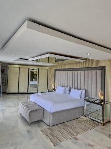 a large bedroom with a large bed and a table at Nandoni Waterfront Resort in Thohoyandou