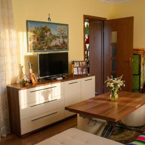 a living room with a tv and a table at Sea View villa in Baku