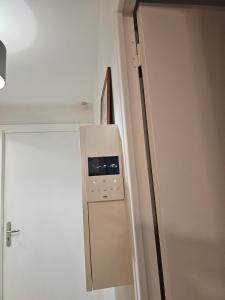 a refrigerator in a room next to a door at Appartement paisible in Quévert