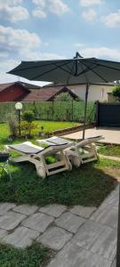 a picnic table and an umbrella on the grass at Casa Carmela in Angera
