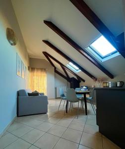 a living room with skylights and a table and chairs at Mokka Loft in Biella