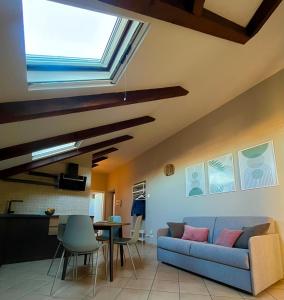 a living room with a blue couch and a table at Mokka Loft in Biella