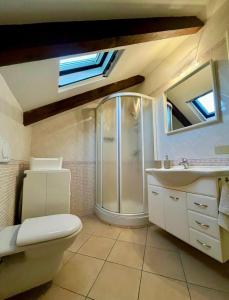 a bathroom with a shower and a toilet and a sink at Mokka Loft in Biella +4 photos