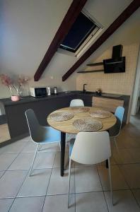 a kitchen and dining room with a table and chairs at Mokka Loft in Biella