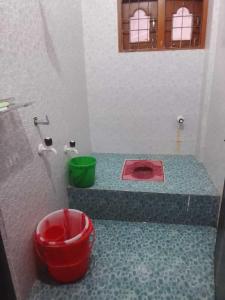 a bathroom with a red sink on a counter at A Homestay in Amingaon