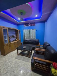 a living room with a couch and a table at A Homestay in Amingaon