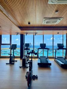 a gym with cardio machines in a room with windows at RARA HM Suites in Hulhumale +17 photos