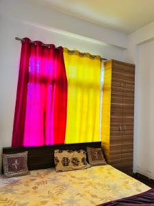 a bedroom with a bed and a colorful curtain at Rr Complex in Nalmatha