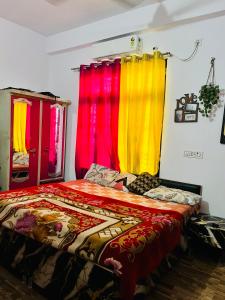 a bed with colorful curtains in a room at Rr Complex in Nalmatha