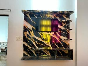 a painting on a wall in a room at Rr Complex in Nalmatha