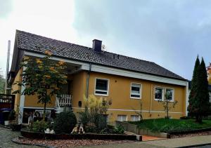 a yellow house with a garden in front of it at MarEwa 80 qm apartment in Mechernich