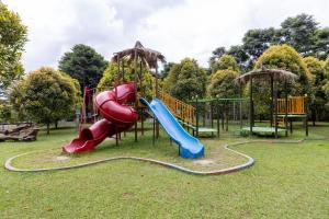 a playground with a slide and a slidesktop at Glamping Camphills in Gunungpicung
