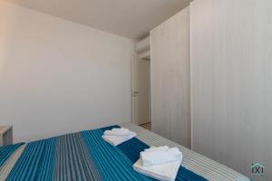 a bedroom with a bed with towels on it at Vetera Boutique by IXIHOME in Varese +41 photos