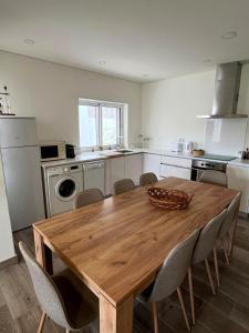 a kitchen with a wooden table and chairs at Casa Germano in Sabugal