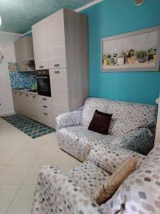 a living room with a couch and a kitchen at Casa della Pace by Pinuccia in Roccaspinalveti