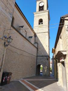 a building with a clock tower on top of it at Casa della Pace by Pinuccia in Roccaspinalveti
