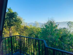a balcony with a view of the jungle at Skyline Haven Ella Cabana in Ella +17 photos