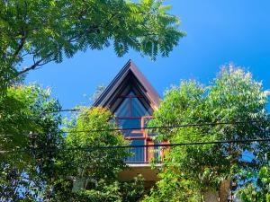 a house with a red roof between trees at Skyline Haven Ella Cabana in Ella